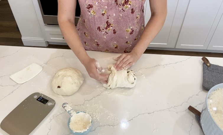 Aimee Guess folding sourdough cinnamon swirl raisin bread and doing a preshaping with sourdough dough